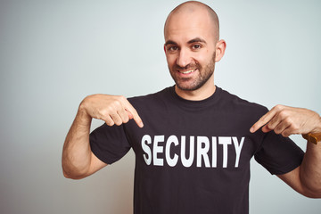 Young safeguard man wearing security uniform over isolated background looking confident with smile...