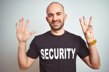 Young safeguard man wearing security uniform over isolated background showing and pointing up with...