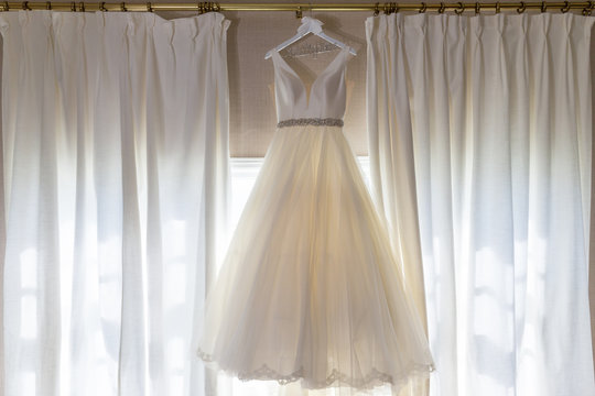 wedding dress gown hang window light event party