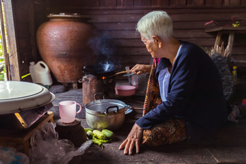 Portrait of Senior asian woman chef cook in the kitchen, Countryside in Thailand