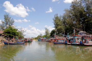 Fototapeta premium fishing boat in canal with beautiful sky background