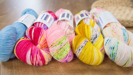 Row of vibrant variegated yarn skeins