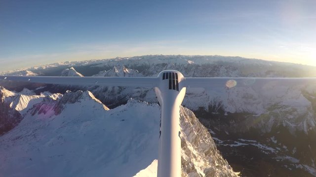 Glider Flying over the Austrian Alp on a sunny day.