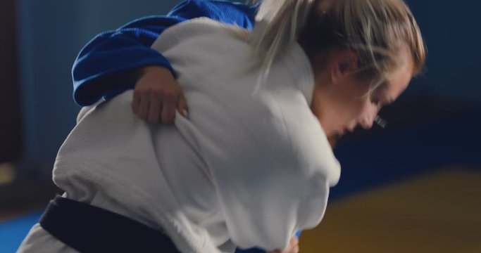 Beautiful girls are fighting in a kimono, grabbing hands. Close-up.
