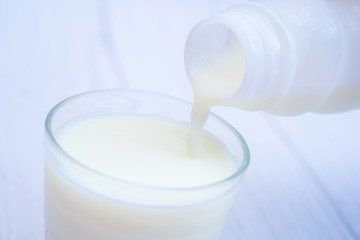 pouring fresh milk into glass