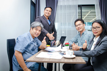 4 people working group, meeting at a small office