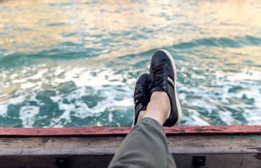 Relax your feet on the side of the ship.