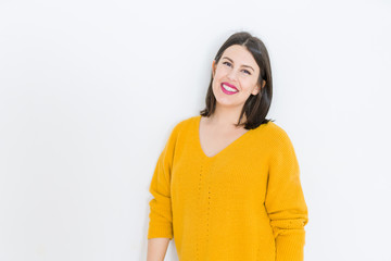 Obraz premium Beautiful brunette young woman smiling confident and cheerful over isolated white background wearing casual yellow sweater