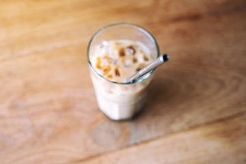 Top view image of a glass of iced coffee with stainless steel drinking straw