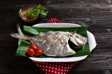 Steamed fish,  Thai food, on dark wood background