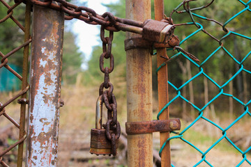 old rusty padlock on a fence