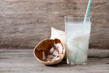 Fresh coconut juice in a glass with coconut white meat isolated on white