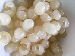 Fresh Longan, Dimocarpus longan meat was removed from longan bark in a white blow, Thai fruit. cooking concept.