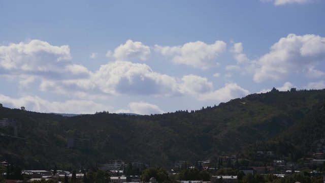 Helicopter with a movie camera on the nose flying over the city and takes a movie