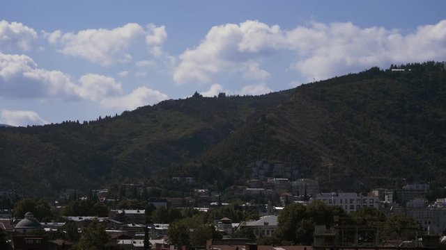 Helicopter with a movie camera on the nose flying over the city and takes a movie