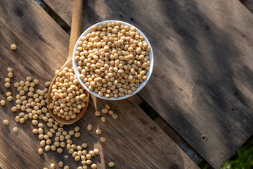 Soy milk cool and soybeans on wooden table background with lighting in the morning