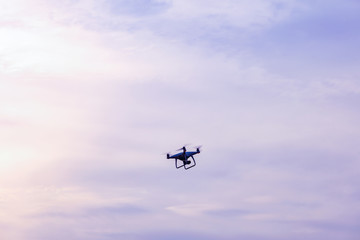 Fototapeta na wymiar Drone Flying in The Sky at Sunrise