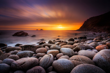 The sun sets at Porth Nanven in Cornwall - obrazy, fototapety, plakaty