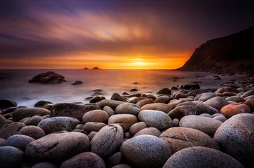 Tuinposter The sun sets at Porth Nanven in Cornwall © allouphoto