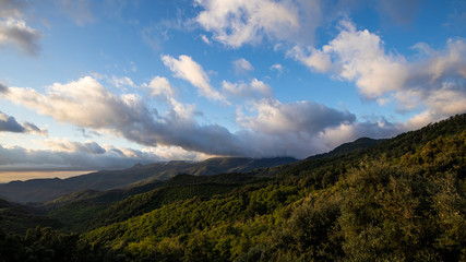 Cloudscape sunrise in Catalan Pyrenees over green mountains