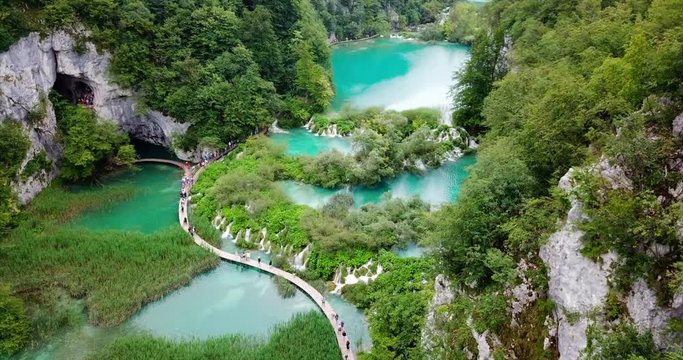 Amazing Plitvice Lakes and Tourists Walking on Water Path