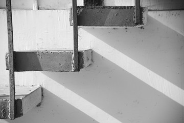 Monochrome background of stone stairs and metal construction with shadow