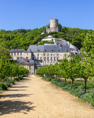 The tower of Chateau de La Roche-Guyon is perched atop the hill above the new chateau and garden - obrazy, fototapety, plakaty