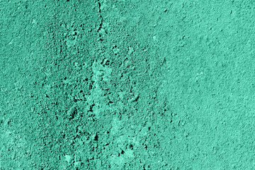 Old grungy cracked green monochromatic weathered wall paint peeling off rusted metal sheet. Textured background for posters and bloggers