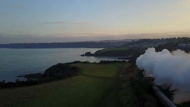 Chasing a steam train Paignton Goodrington Devon UK. Aerial view using a drone.