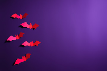 bats papercut in purple background for halloween