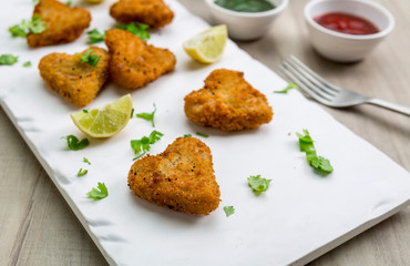 Heart shape cutlets with sauce and green chutney