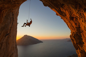 Silhouette of a climber falling on a rope above the Mediterranean sea with another island in view..  © Shawn Tron
