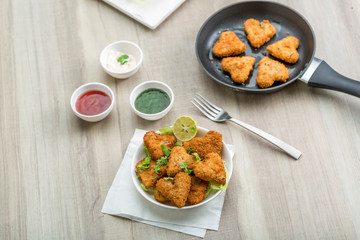 Heart shape cutlets with sauce and green chutney