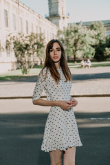 Young cute girl walking in city park