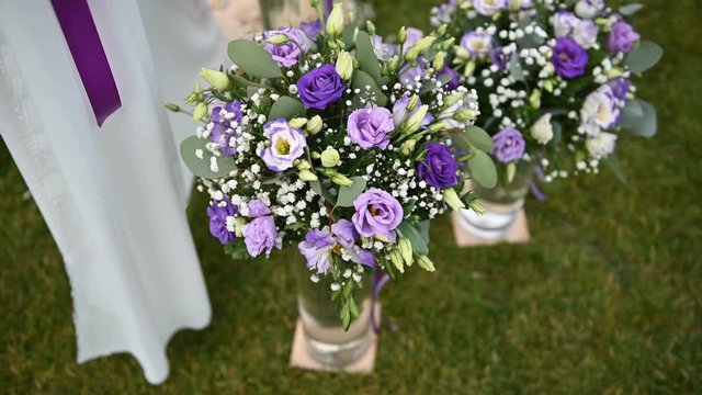 beautiful purple flowers near the arch for an outdoor ceremony