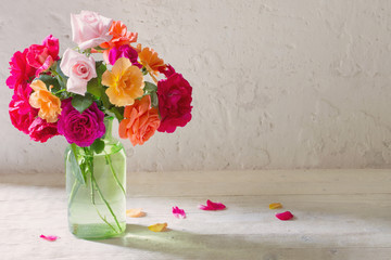 roses in vase on background white wall