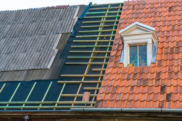 Repair of the roof of the building. Replacing old slate with tiles.