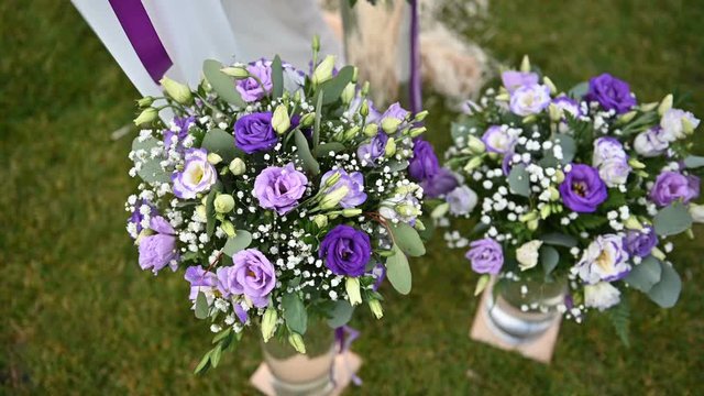 beautiful purple flowers near the arch for an outdoor ceremony