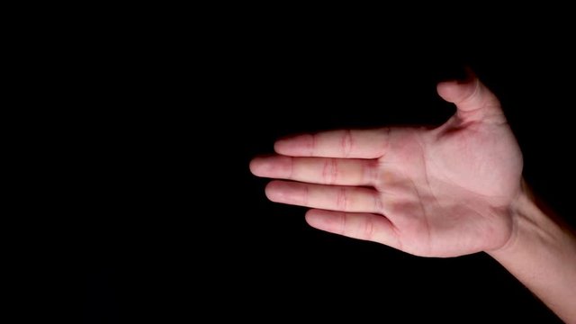 A Hand Performing Finger Gestures Against Black Background 
