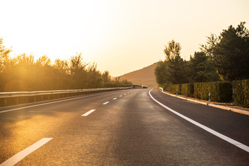 Sunset on straight country road