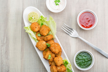 Button cutlets with sauce and green chutney