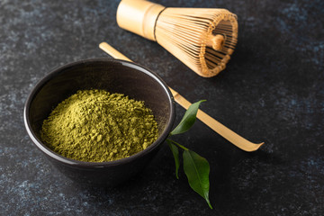 Organic Green Matcha Tea in a Bowl on dark background.