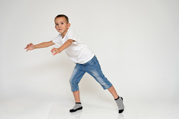 Full-length portrait on a white background of a cute boy child with Vitiligo disease - a violation...