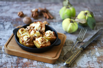 Baked quince with sweet cheese, cinnamon and nuts. Healthy dessert. Keto diet.