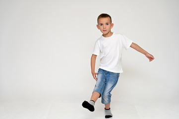 Full-length portrait on a white background of a cute boy child with Vitiligo disease - a violation...