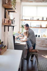 Helpful daddy teaching daughter to wash the dishes