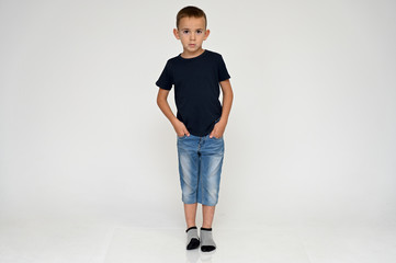 Full-length portrait on a white background of a cute boy child with Vitiligo disease - a violation...