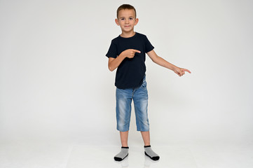Full-length portrait on a white background of a cute boy child with Vitiligo disease - a violation...