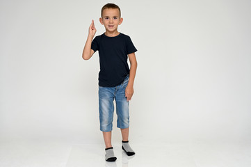 Full-length portrait on a white background of a cute boy child with Vitiligo disease - a violation...