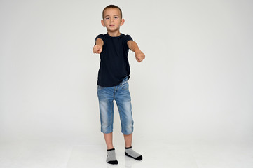 Full-length portrait on a white background of a cute boy child with Vitiligo disease - a violation...